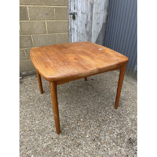 160 - An extending teak dining table marked AM MADE IN DENMARK to underside