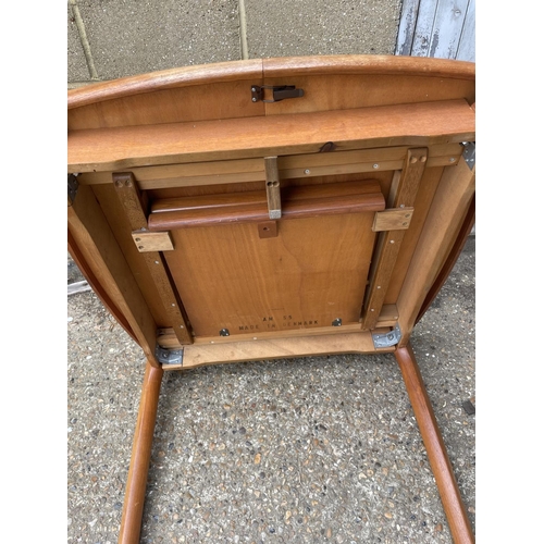 160 - An extending teak dining table marked AM MADE IN DENMARK to underside