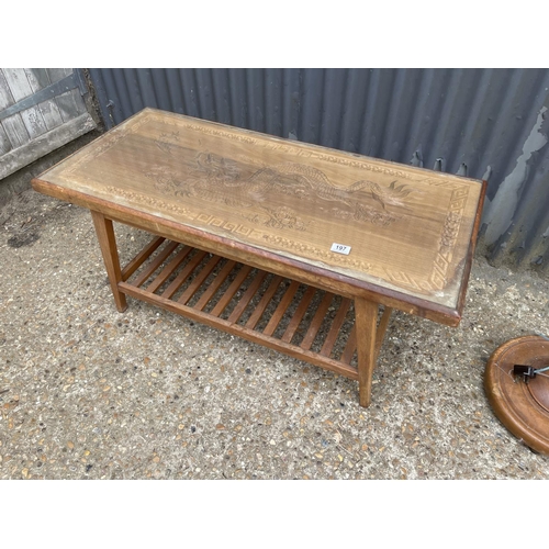 197 - A carved oriental hardwood coffee table together with standard lamp