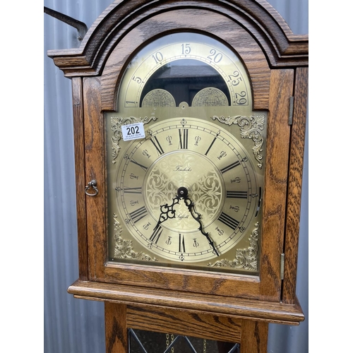 202 - A reproduction oak cased long case clock