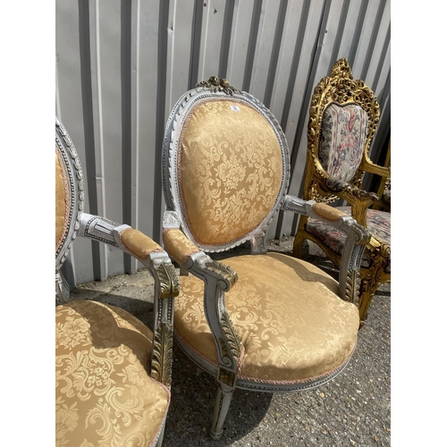 22 - A pair of grey painted and peach upholstered continental elbow chairs