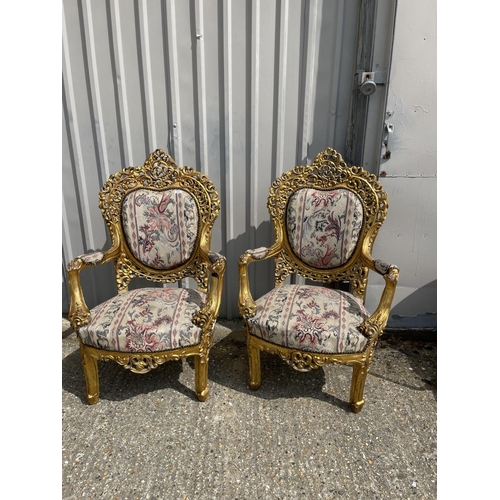 23 - A pair of gold gilt framed throne chairs with ornate decoration and tapestry upholstery