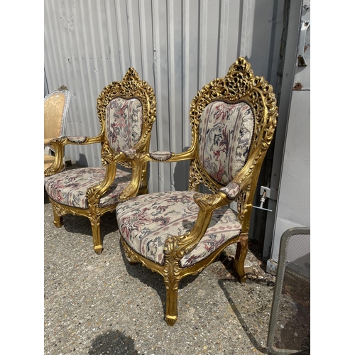 23 - A pair of gold gilt framed throne chairs with ornate decoration and tapestry upholstery