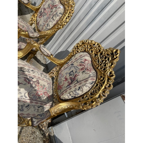 23 - A pair of gold gilt framed throne chairs with ornate decoration and tapestry upholstery