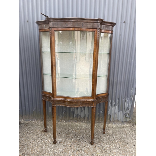 27 - A french mahogany display cabinet on stand, carved decoration with bow glass panels and door 120x40x... 