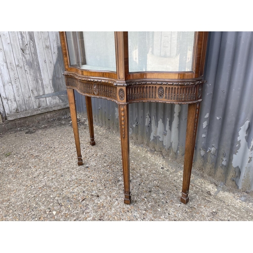 27 - A french mahogany display cabinet on stand, carved decoration with bow glass panels and door 120x40x... 