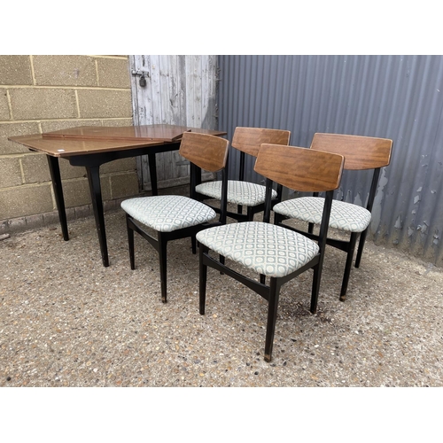 34 - A retro teak extending dining table with four chairs