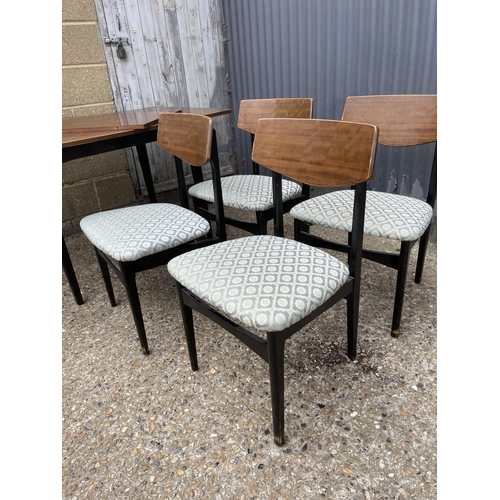 34 - A retro teak extending dining table with four chairs