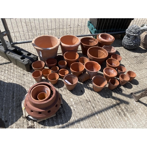 374 - A large collection of assorted terracotta pots