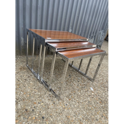 39 - A merrow associates style chrome and rosewood nest of three occasional tables