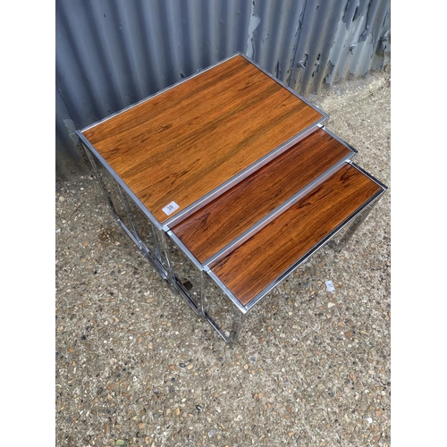 39 - A merrow associates style chrome and rosewood nest of three occasional tables