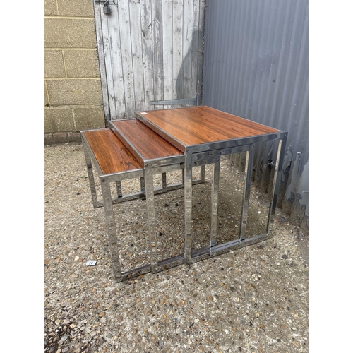 39 - A merrow associates style chrome and rosewood nest of three occasional tables