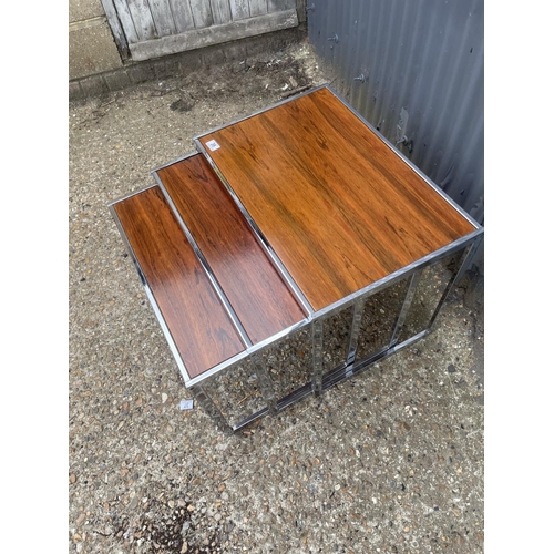 39 - A merrow associates style chrome and rosewood nest of three occasional tables