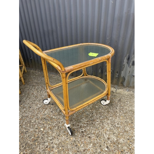 4 - A vintage bamboo next of three with frosted glass tops together with matching drinks trolley