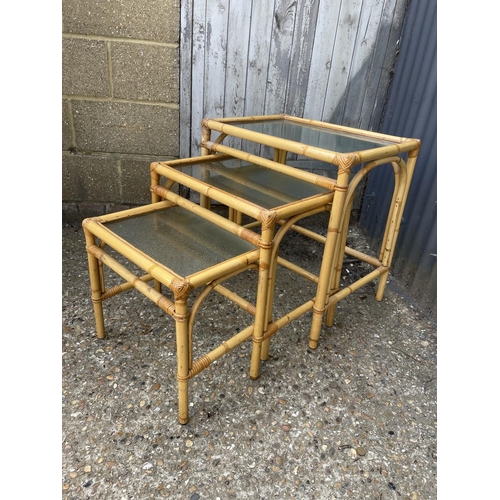 4 - A vintage bamboo next of three with frosted glass tops together with matching drinks trolley