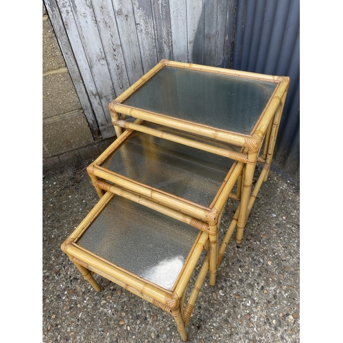 4 - A vintage bamboo next of three with frosted glass tops together with matching drinks trolley