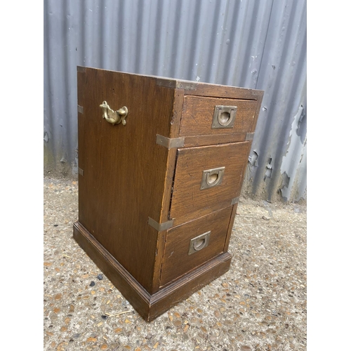 43 - A campaign style three drawer bedside 30x40x60