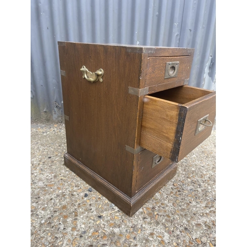 43 - A campaign style three drawer bedside 30x40x60