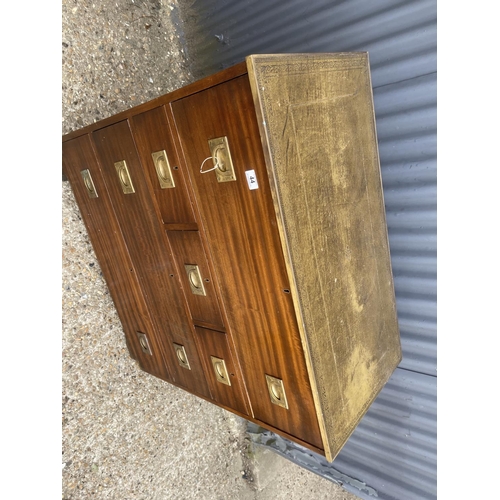 44 - A military style secretaire chest of five drawers with green leather top