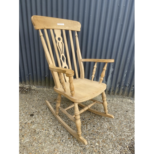 52 - A farmhouse style pine rocking chair