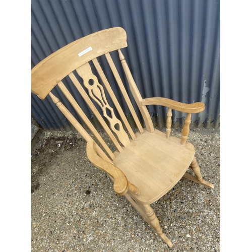 52 - A farmhouse style pine rocking chair