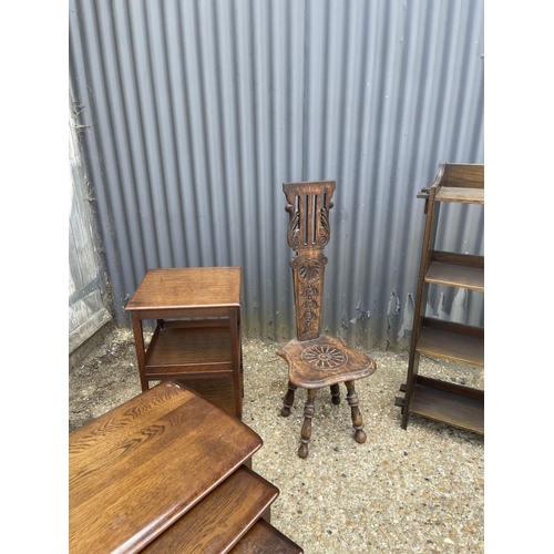 55 - AN OAK BOOKCASE, NEST OF THREE, BOOK TABLE AND CARVED SPINNING CHAIR