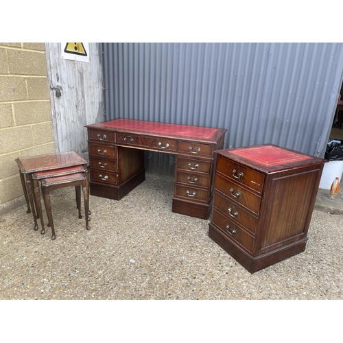 56 - A reproduction mahogany twin pedestal desk together with matching filing cabinet and nest of three