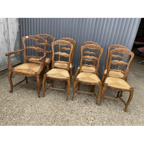 77 - A set of 8 french oak dining chairs with rush seats