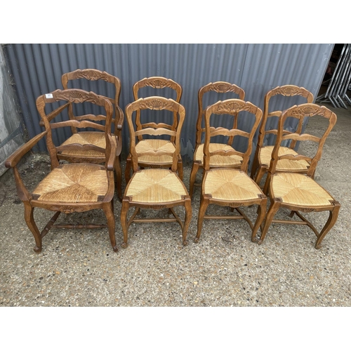 77 - A set of 8 french oak dining chairs with rush seats