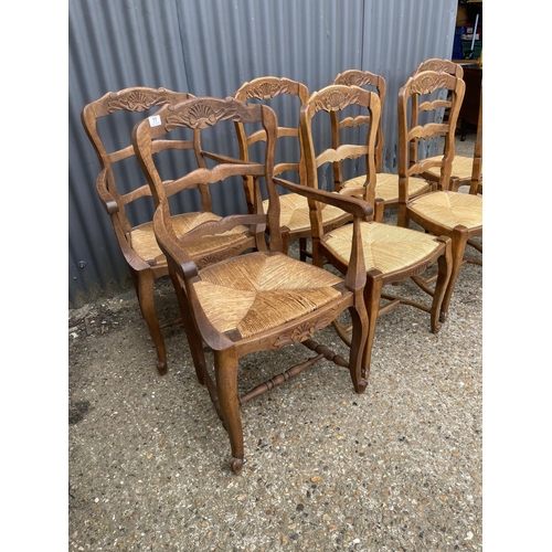 77 - A set of 8 french oak dining chairs with rush seats