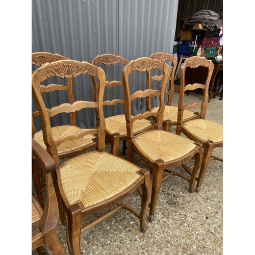 77 - A set of 8 french oak dining chairs with rush seats