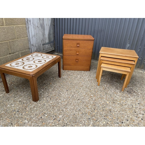 82 - A teak chest of three drawers, teak nest of three and a g plan coffee table