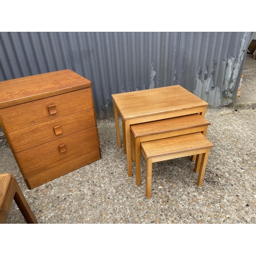 82 - A teak chest of three drawers, teak nest of three and a g plan coffee table