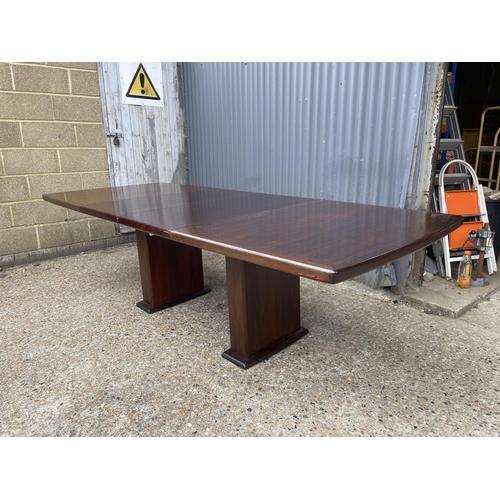 93 - A large extending danish rosewood dining table possibly by koefod with 2 extension leaves and glass ... 