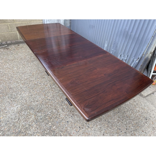 93 - A large extending danish rosewood dining table possibly by koefod with 2 extension leaves and glass ... 