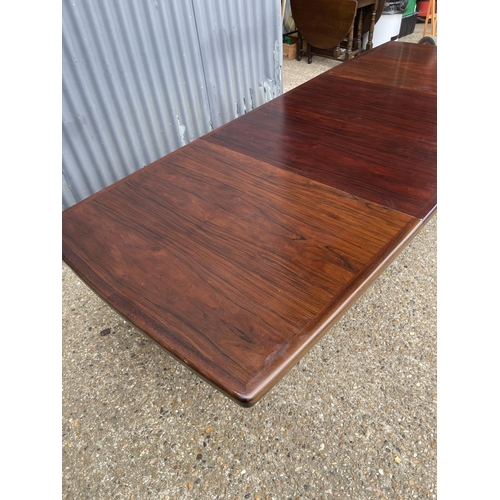 93 - A large extending danish rosewood dining table possibly by koefod with 2 extension leaves and glass ... 