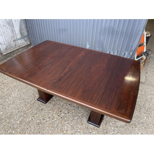 93 - A large extending danish rosewood dining table possibly by koefod with 2 extension leaves and glass ... 