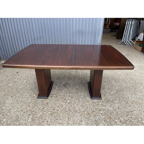 93 - A large extending danish rosewood dining table possibly by koefod with 2 extension leaves and glass ... 