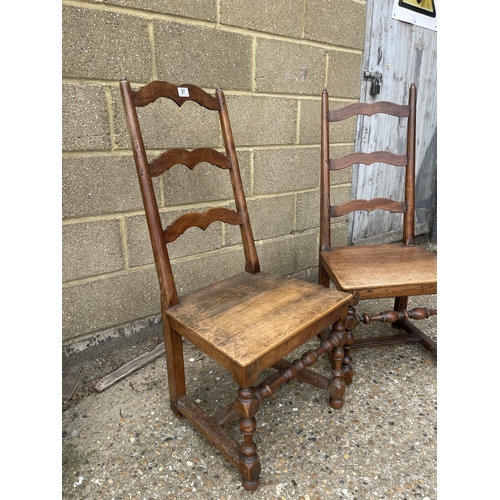 97 - A pair of country style ladder back chairs