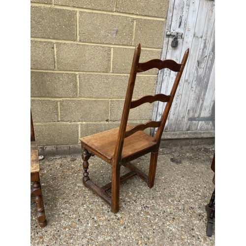 97 - A pair of country style ladder back chairs