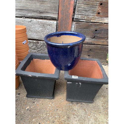 370 - A pair of black glazed planters and a blue pot