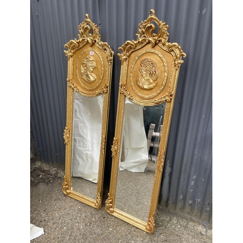 363 - A pair of large ornate gold gilt mirrors decorated with ladies facing each other 180x50 each