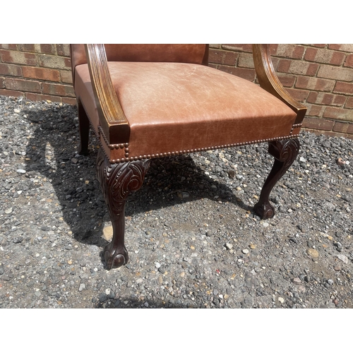 1 - A mahogany framed brown leather upholstered desk chair on ball and claw feet