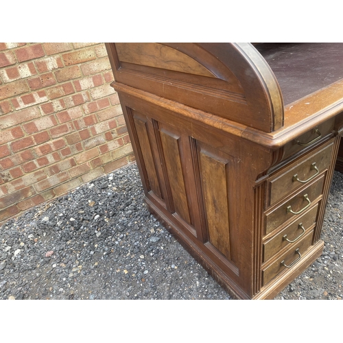 11 - A large good quality American walnut patent roll top desk with fitted interior and 9 locking drawers... 