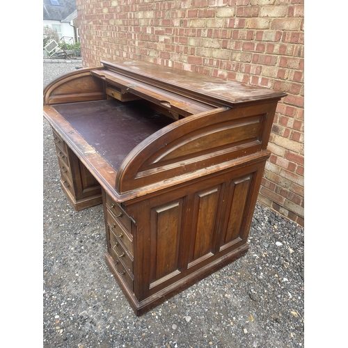 11 - A large good quality American walnut patent roll top desk with fitted interior and 9 locking drawers... 