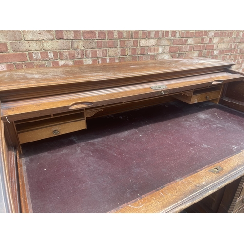 11 - A large good quality American walnut patent roll top desk with fitted interior and 9 locking drawers... 