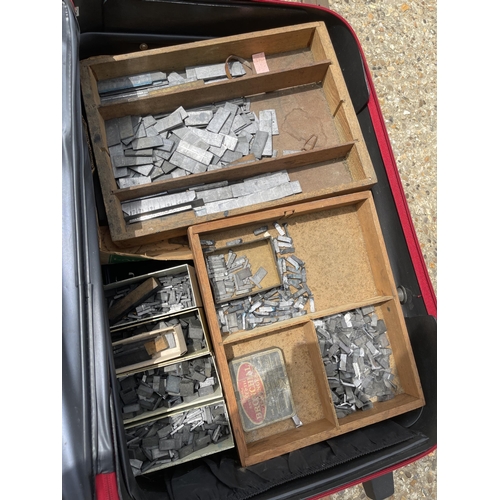 110 - Two cases of printing blocks together with two print trays loaded with lead punches, an empty tray a... 