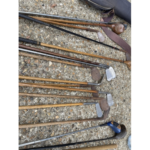 113 - A collection of vintage golf clubs in bag