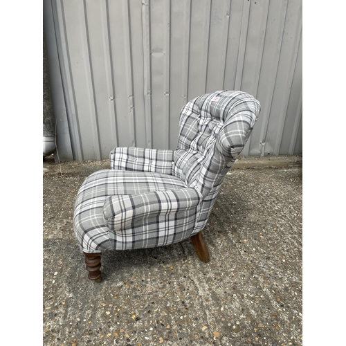 121 - A Victorian button back nursing chair recently upholstered in grey tartan