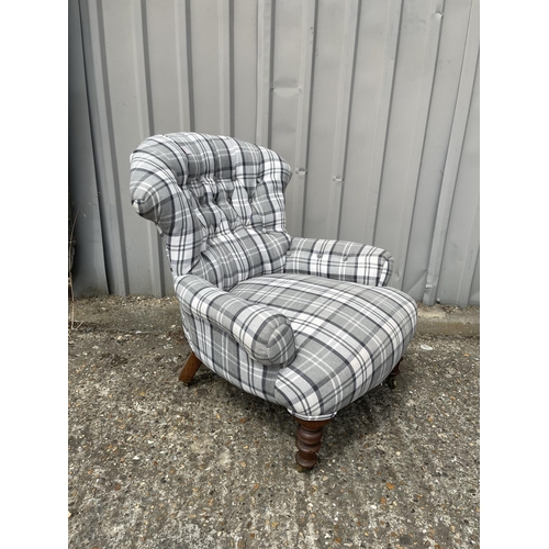 121 - A Victorian button back nursing chair recently upholstered in grey tartan